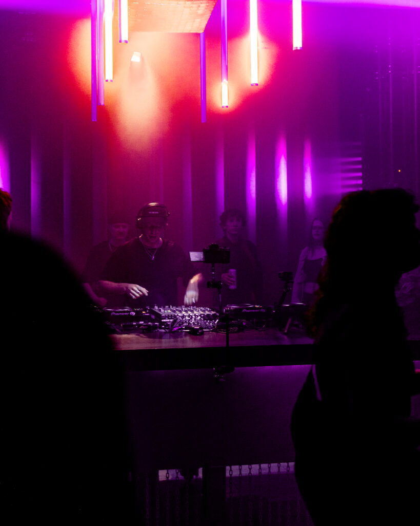 DJ performing a live set for a crowd at N29 Studio with purple stage lighting