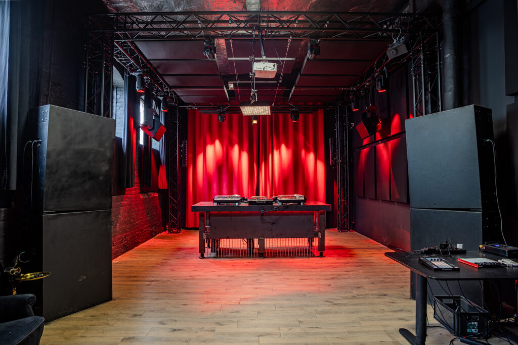 N29 Studio Main Room with red curtain backdrop and DJ decks